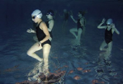 Aliens.  Training of a group of young synchro swimmers in... by Alena Vorackova 